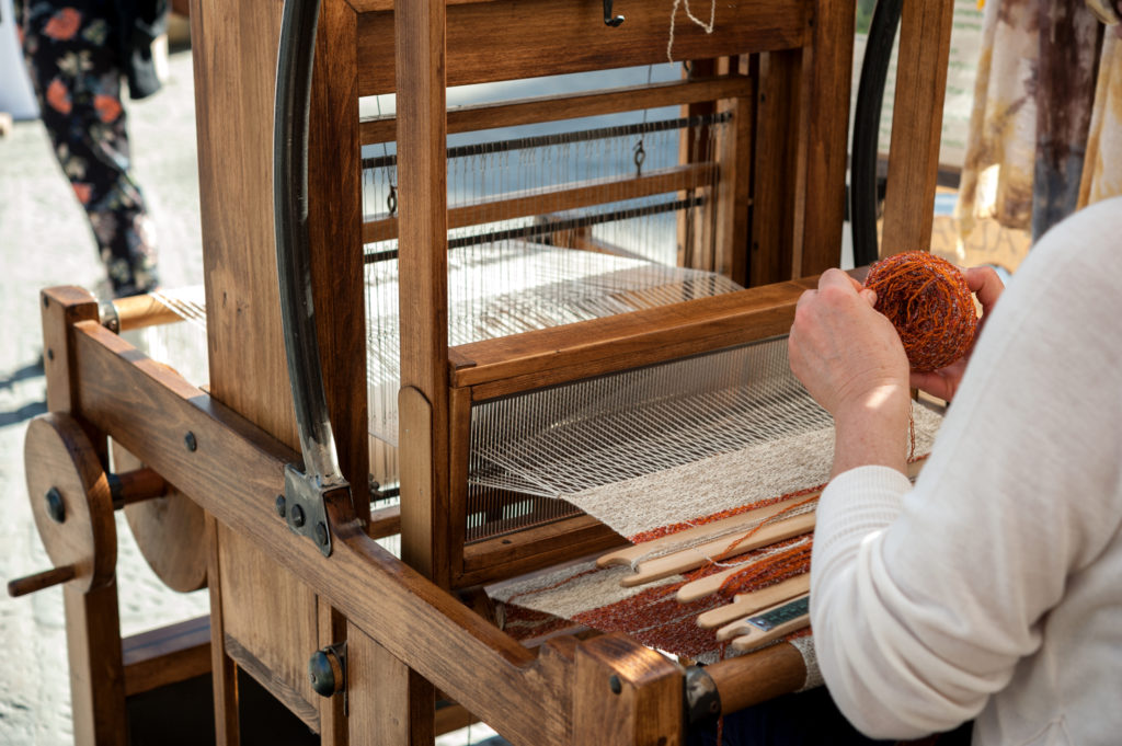 Woman weaving wool in traditional way at manual loom. - Buckhorn Inn